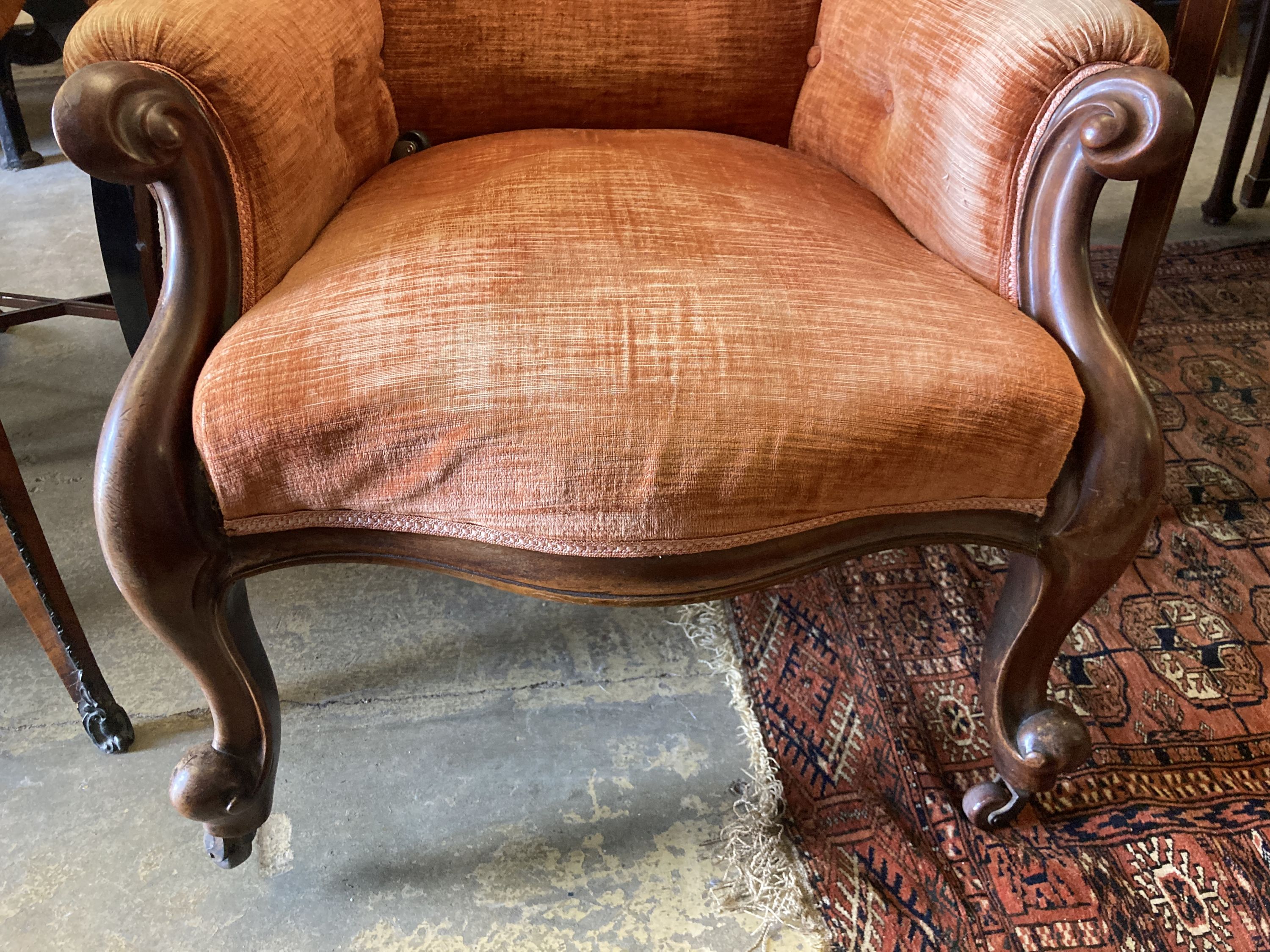 A Victorian carved mahogany spoonback armchair, width 72cm, depth 70cm, height 105cm